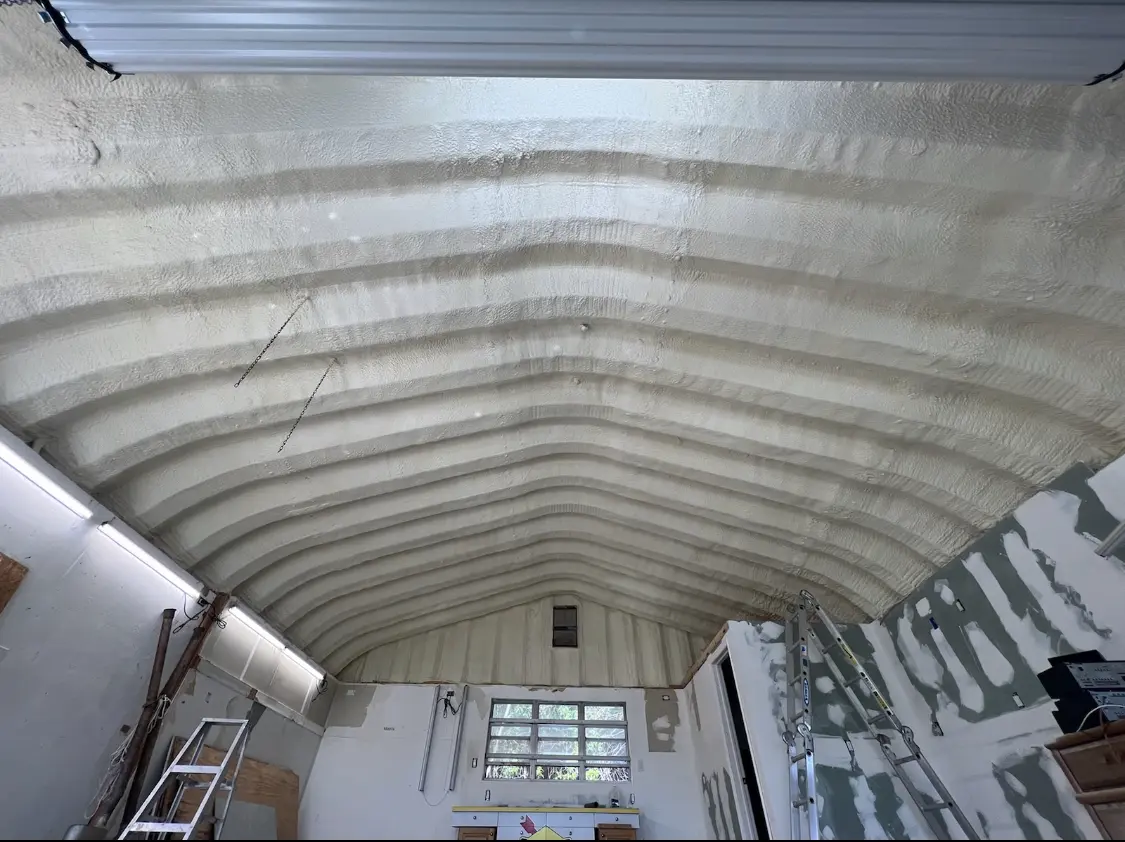 Spray polyurethane foam applied to the underside of a metal roof deck in Wolfforth